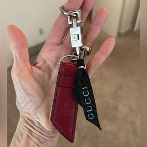 Authentic Gucci lock, leather piece and ribbon keychain